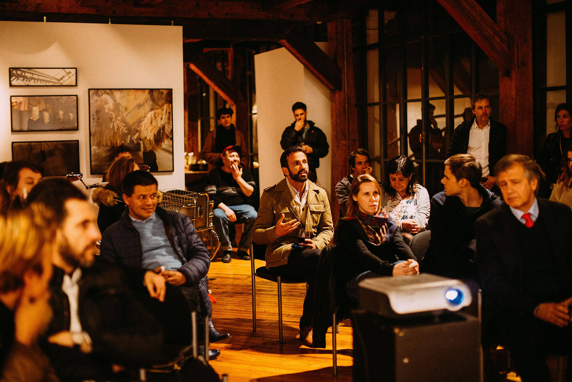 group of people gathered together and sitting for a meeting and presentation