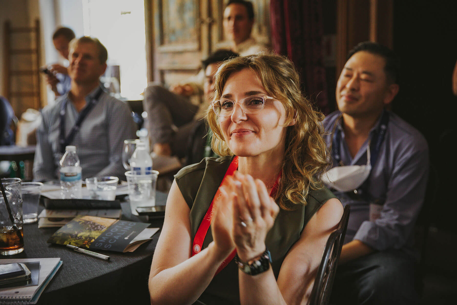 group of people listening to a speaker in a conference setting