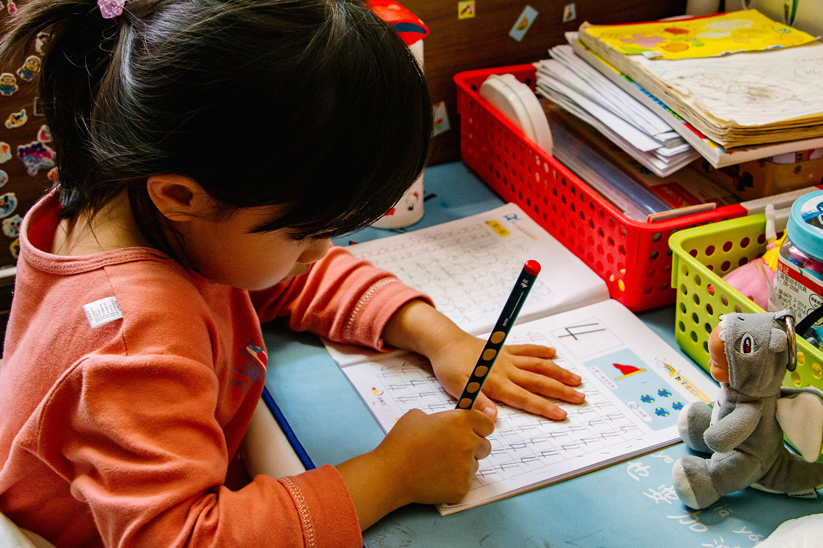 Child at school desk working in a math book