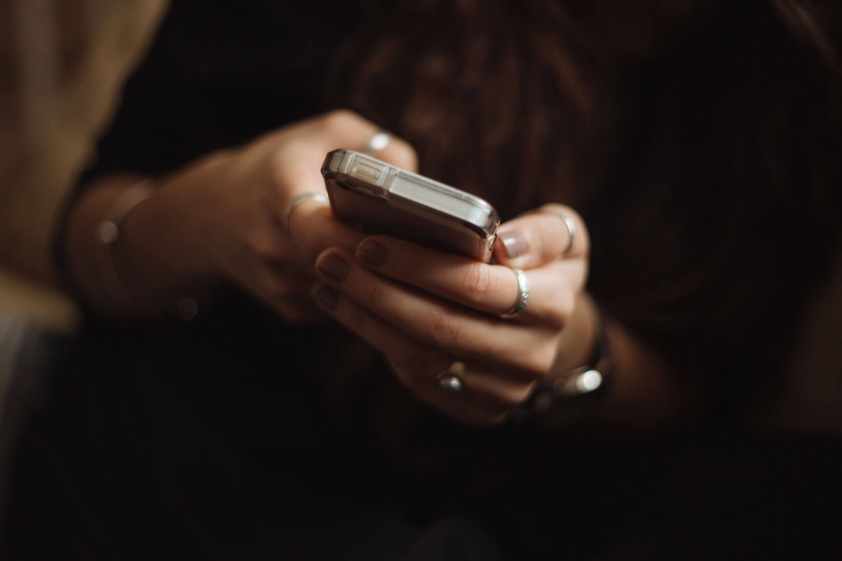 close up of woman holding a cell phone