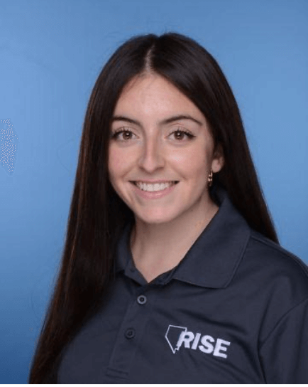 Smiling woman with long dark hair in blue polo shirt