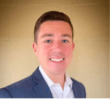 Tyler Rajchel Smiling man in jacket and button down shirt